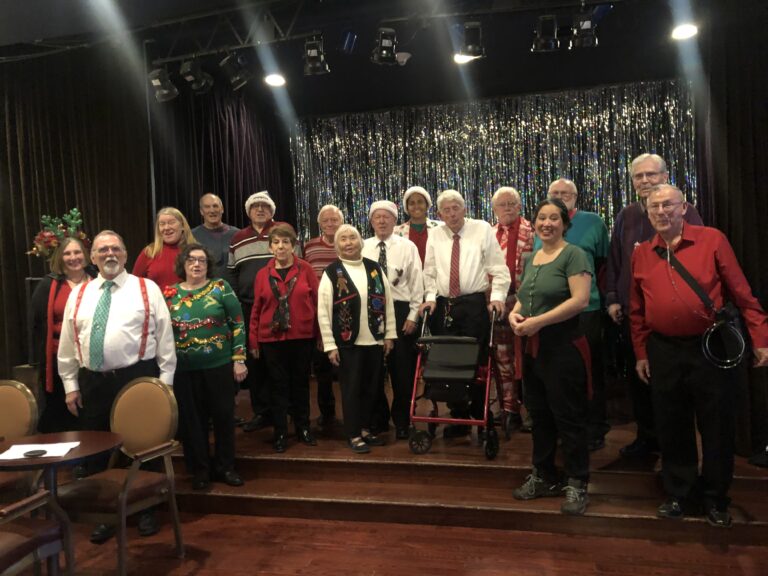 Men and women singing at a Christmas event