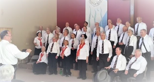 Men and women singing in a concert.